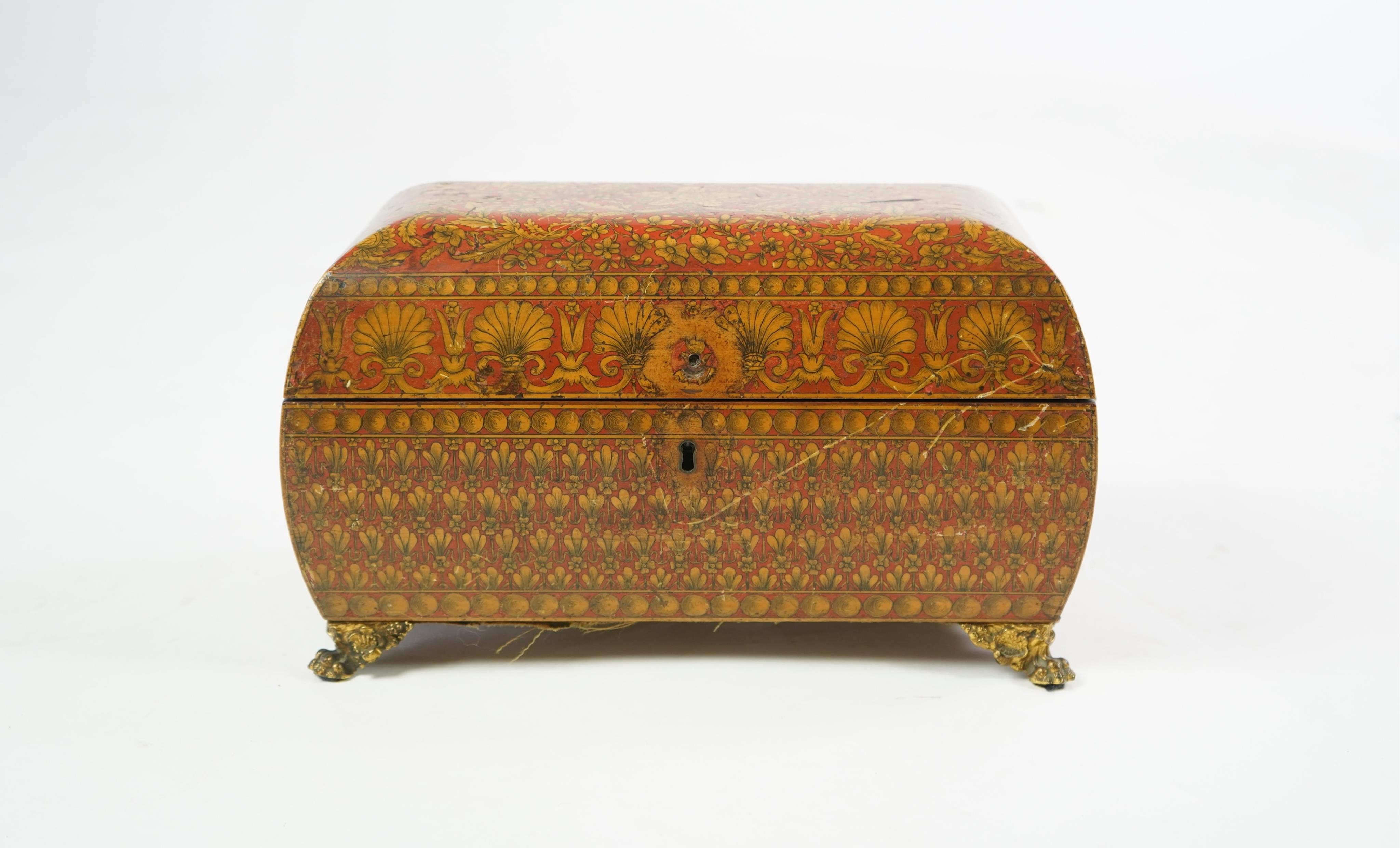 A Regency red lacquer penwork tea caddy
